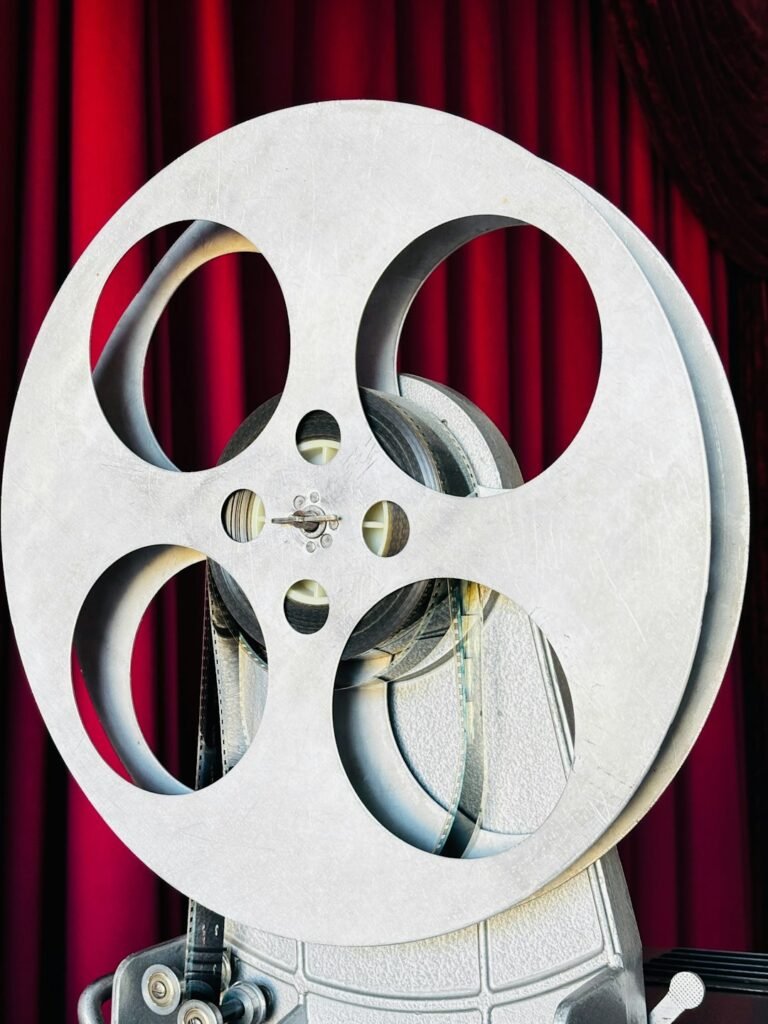 Kırmızı kadife perde önünde vintage film projeksiyon makarası